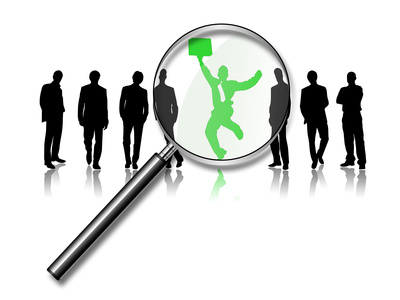 magnifying glass over the top of a green man standing out from a crowd of other men